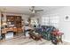 Comfortable living room features a ceiling fan, wood flooring and ample natural light at 4647 Gazebo Ct, New Port Richey, FL 34655