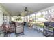 Spacious screened patio with ceiling fans, comfortable seating, and a view of the lush backyard at 4647 Gazebo Ct, New Port Richey, FL 34655