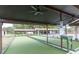 View of shuffleboard courts featuring shaded seating, with social distancing signage, for enjoyable outdoor recreation at 4647 Gazebo Ct, New Port Richey, FL 34655