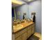 Compact bathroom featuring a single vanity, countertop storage and framed mirror for personal care at 4678 Marine Pkwy # 305, New Port Richey, FL 34652
