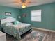 Comfortable bedroom featuring queen bed, ceiling fan, and light wood flooring at 4678 Marine Pkwy # 305, New Port Richey, FL 34652