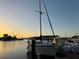 Docked sailboat with sunset colors reflecting on the water at 4678 Marine Pkwy # 305, New Port Richey, FL 34652
