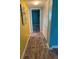 Hallway leads to other rooms; closet offers extra storage; flooring appears to be wood-look vinyl at 4678 Marine Pkwy # 305, New Port Richey, FL 34652