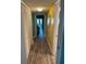 Inviting hallway with wood floors leading into a bedroom at 4678 Marine Pkwy # 305, New Port Richey, FL 34652