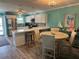 Bright kitchen with white cabinets, stainless steel appliances, and breakfast bar seating at 4678 Marine Pkwy # 305, New Port Richey, FL 34652