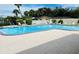 Beautiful community swimming pool surrounded by lounge chairs at 4678 Marine Pkwy # 305, New Port Richey, FL 34652