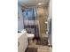 This recently remodeled walk-in shower features neutral tiling and overhead rain shower fixture with removable wand at 4678 Marine Pkwy # 305, New Port Richey, FL 34652