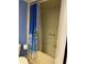 A full shower features a blue-toned curtain with a palm tree design, and is separate from the toilet at 4678 Marine Pkwy # 305, New Port Richey, FL 34652