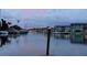 Waterfront view of boats docked along the canal, with well-maintained buildings and tropical landscaping at 4678 Marine Pkwy # 305, New Port Richey, FL 34652