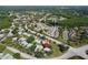 Aerial view showcasing the location of the property with surrounding trees and community at 4836 Alamo Ct, New Port Richey, FL 34655