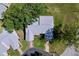 Aerial view of a well-maintained home with a gray roof, lush lawn, and mature trees at 4836 Alamo Ct, New Port Richey, FL 34655