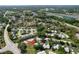 Aerial view of community with ponds, manicured landscaping, and the property indicated by a red arrow at 4836 Alamo Ct, New Port Richey, FL 34655