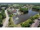 A lovely aerial view of the community amenities, showcasing the pool and lake at 4836 Alamo Ct, New Port Richey, FL 34655