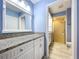 Bathroom vanity with granite countertop and walk-in shower at 4836 Alamo Ct, New Port Richey, FL 34655