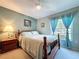 Cozy bedroom with a wooden bed frame, soft carpet, and ample natural light at 4836 Alamo Ct, New Port Richey, FL 34655