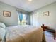 Relaxing bedroom with carpeted floors, natural light, and a comfortable bed at 4836 Alamo Ct, New Port Richey, FL 34655