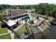 Community pool area overlooking the lake, featuring lounge chairs and covered picnic areas at 4836 Alamo Ct, New Port Richey, FL 34655