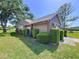 Charming home exterior showcasing manicured landscaping with trimmed bushes and a well-maintained lawn at 4836 Alamo Ct, New Port Richey, FL 34655