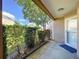Covered entryway with trimmed shrubs, small trees and an immaculate front yard at 4836 Alamo Ct, New Port Richey, FL 34655