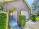 A low angle view shows the exterior of the home featuring address numbers, an arched entryway, and groomed shrubbery at 4836 Alamo Ct, New Port Richey, FL 34655