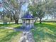 Charming gazebo nestled among mature trees in a well-maintained community green space at 4836 Alamo Ct, New Port Richey, FL 34655