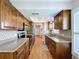 Well-lit kitchen with granite countertops, stainless steel appliances, and wood flooring at 4836 Alamo Ct, New Port Richey, FL 34655