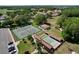 Aerial view of tennis and shuffleboard courts, surrounded by green spaces and parking at 4836 Alamo Ct, New Port Richey, FL 34655