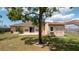 Backyard featuring a shed, patio, well-maintained lawn, and view of the house at 5092 Roble Ave, Spring Hill, FL 34608