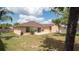 A spacious backyard features a cozy patio and well-maintained lawn at 5092 Roble Ave, Spring Hill, FL 34608
