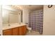Bathroom with a double sink vanity and shower with decorative shower curtain at 5092 Roble Ave, Spring Hill, FL 34608