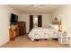 Neutral bedroom with a ceiling fan, carpeted floors and a comfortable bed at 5092 Roble Ave, Spring Hill, FL 34608