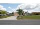 Charming single-story home featuring a well-maintained lawn, long driveway, and a welcoming facade at 5092 Roble Ave, Spring Hill, FL 34608