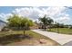 A charming single-story home with lush front lawn, a concrete driveway, and palm trees at 5092 Roble Ave, Spring Hill, FL 34608