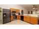 Spacious kitchen with stainless steel appliances, oak cabinets, and tile floors at 5092 Roble Ave, Spring Hill, FL 34608