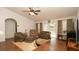 Bright living room with hardwood floors, ceiling fan and sliding glass doors to the outside at 5092 Roble Ave, Spring Hill, FL 34608