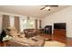 Cozy living room area featuring vaulted ceilings, hardwood floors, and comfortable seating at 5092 Roble Ave, Spring Hill, FL 34608