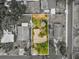 An aerial view showing the home and surrounding landscaped property and neighboring homes at 6329 Alaska Ave, New Port Richey, FL 34653