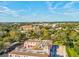 An aerial view of a pink building with terracotta roof tiles amidst lush greenery at 6329 Alaska Ave, New Port Richey, FL 34653
