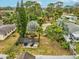 Aerial view of fenced backyard showing mature trees and shaded seating area at 6329 Alaska Ave, New Port Richey, FL 34653