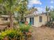 Backyard with mature landscaping, a grill, and comfortable seating area near the house at 6329 Alaska Ave, New Port Richey, FL 34653
