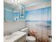 Nautical themed bathroom with decorative beach themed shower curtain and decor at 6329 Alaska Ave, New Port Richey, FL 34653