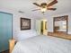 Well-lit bedroom with a large bed, wooden accents, and closet space at 6329 Alaska Ave, New Port Richey, FL 34653