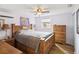 Bedroom featuring hardwood floors, a large bed, a ceiling fan, and natural light at 6329 Alaska Ave, New Port Richey, FL 34653