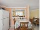 Dining area featuring a view of living room and table with floral print at 6329 Alaska Ave, New Port Richey, FL 34653