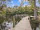 A beautiful wooden dock and pier offers gorgeous views into a calm waterway at 6329 Alaska Ave, New Port Richey, FL 34653