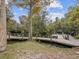 A wooden dock and pier extends into the waterway near green grass and lush trees in the James E. Grey Preserve at 6329 Alaska Ave, New Port Richey, FL 34653