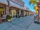 Street-level view of businesses with awnings and potted plants lining the sidewalk under a clear blue sky at 6329 Alaska Ave, New Port Richey, FL 34653