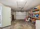 View of the garage with storage shelves, garage door, and a door on the side at 6329 Alaska Ave, New Port Richey, FL 34653