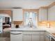 Bright kitchen with white countertops and appliances with connecting dining area at 6329 Alaska Ave, New Port Richey, FL 34653