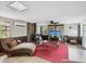 Comfortable living room featuring brick fireplace and ample seating at 6329 Alaska Ave, New Port Richey, FL 34653